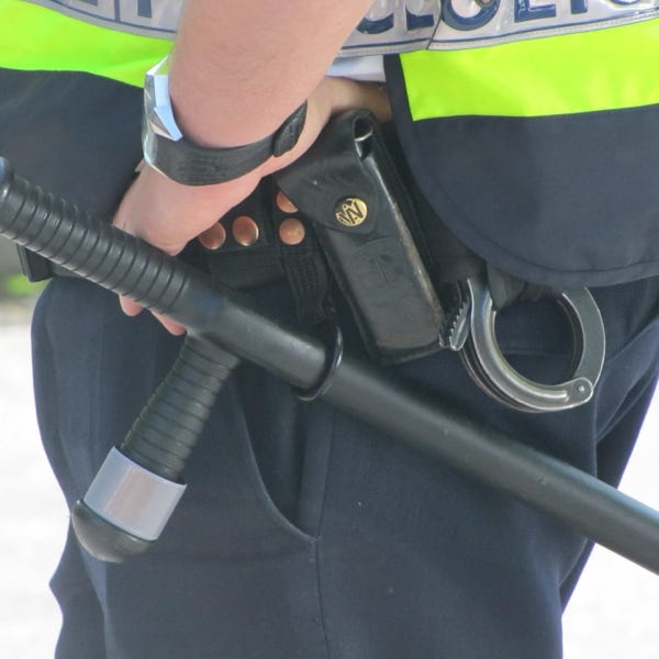 A group of workers carrying heavy bags on a large stack of goods, illustrating teamwork and labor.